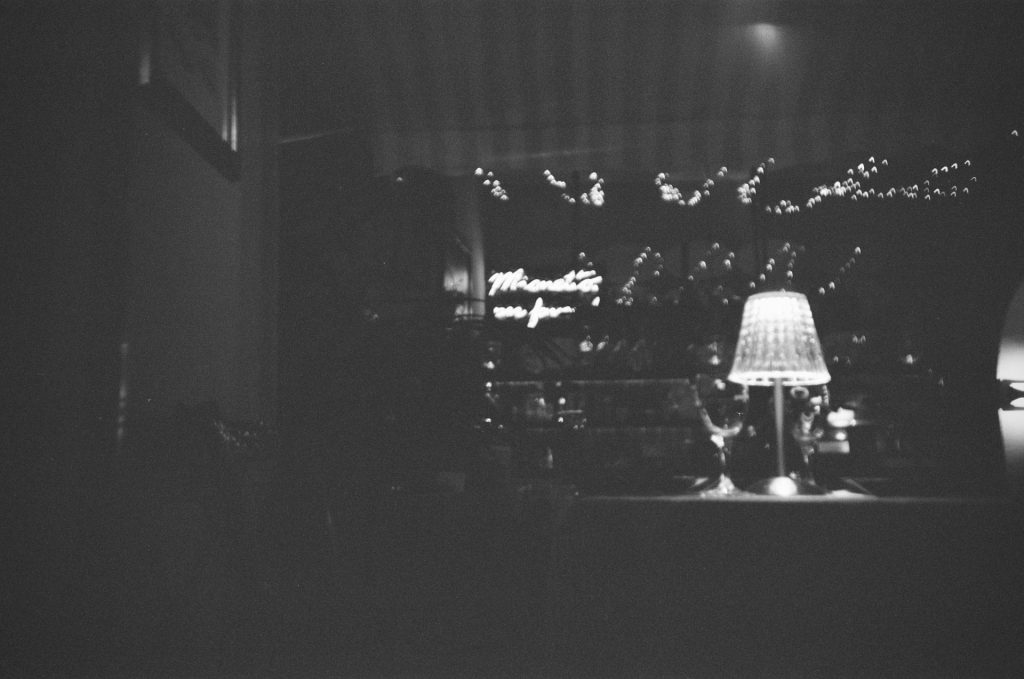 eine Lampe, die auf einem Tisch neben einem Fenster steht